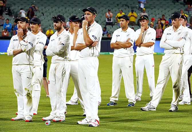 New Zealand's captain Brendon McCullum (left) stands with teammates after they lost the third cricket Test match against Australia at the Adelaide Oval, in South Australia, on Sunday