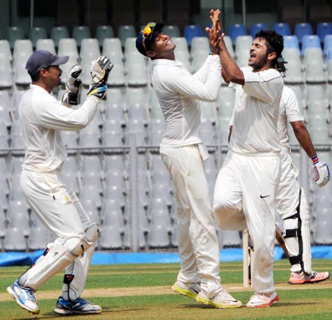Shardul Thakur (right) celebrates with his Mumbai team mates after taking a wicket during the Ranji Trophy match against Punjab at the Wankhede stadium