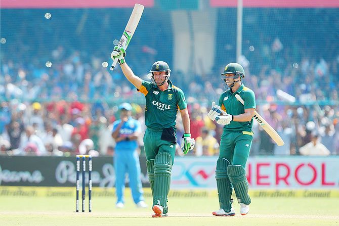 South Africa captain AB de Villiers celebrates his century with teammate Farhaan Behardien during the 1st One Day International against India at the Green Park Stadium in Kanpur, on Sunday