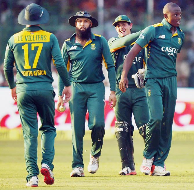  South African players congratulate Kagiso Rabada (right) on taking a wicket