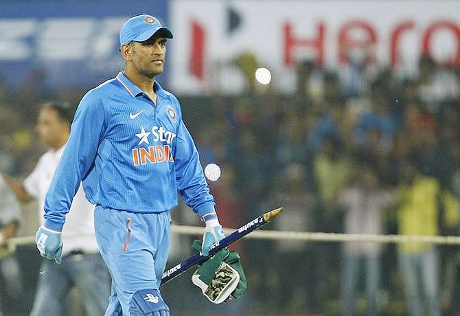 India's captain Mahendra Singh Dhoni walks off the ground after winning the second One-day International cricket match against South Africa in Indore on Wednesday