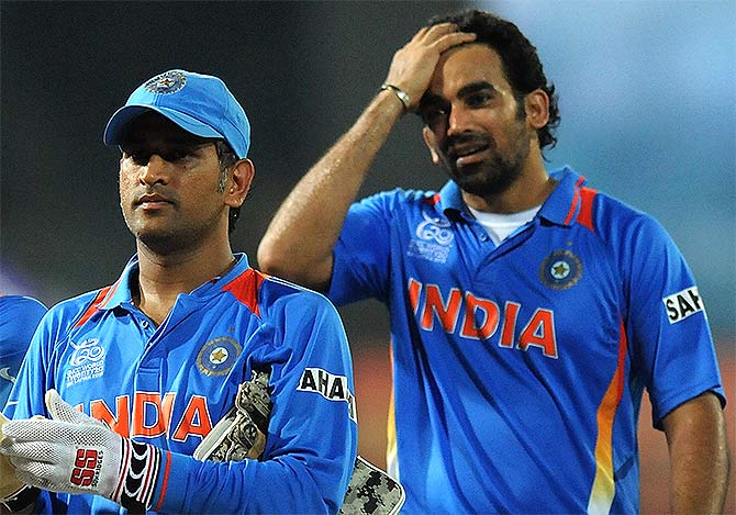 India's MS Dhoni along with teammate Zaheer Khan walk back to the pavilion after a game 