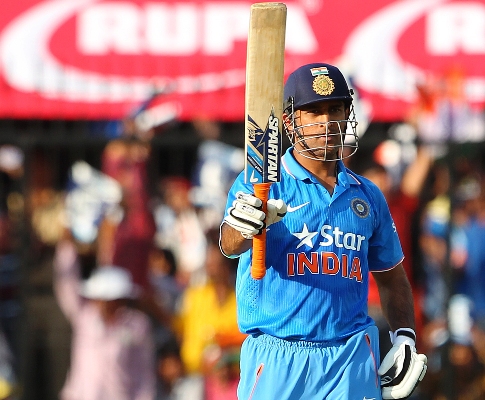 MS Dhoni, captain, of India raises his bat for his fifty 
