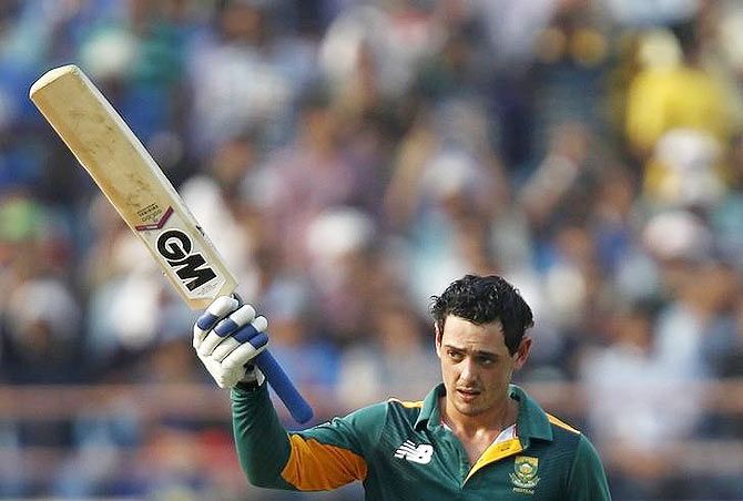 South Africa's Quinton de Kock raises his bat to celebrate scoring his century against India
