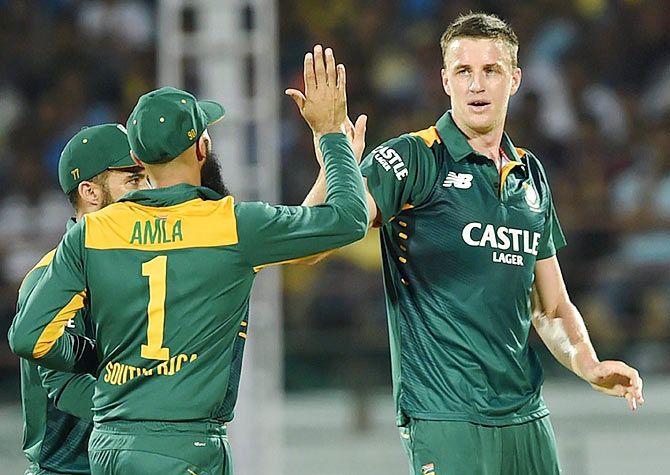 South Africans Morkel (right) celebrates the wicket of Indian batsman Shikhar Dhawan during their 3rd ODI in Rajkot on Sunday