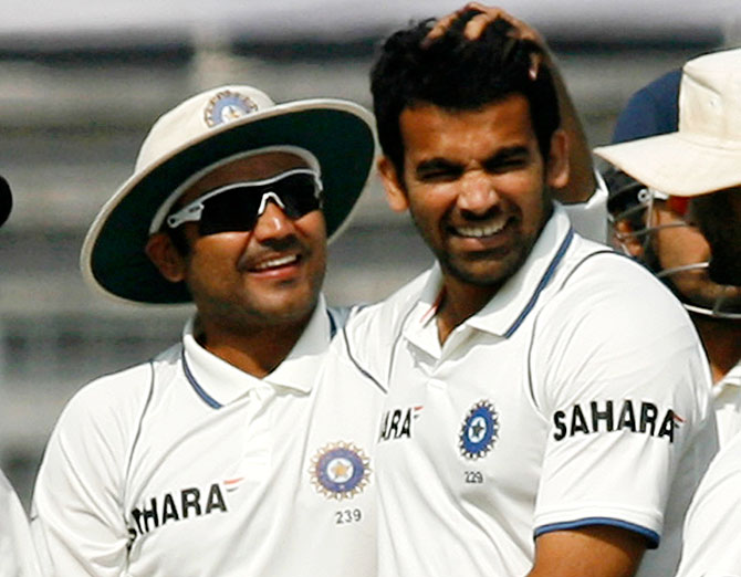 India's Virender Sehwag congratulates bowler Zaheer Khan 