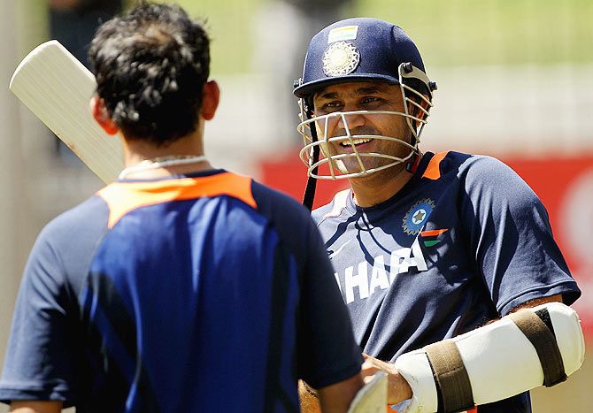 Virender Sehwag (right) speaks with teammate Gautam Gambhir during a nets session