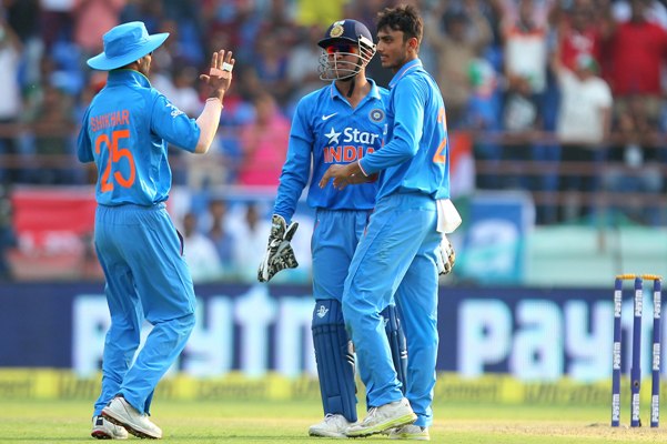 MS Dhoni, captain, of India and Axar Patel celebrate the wicket of AB de Villiers with Shikhar Dhawan  