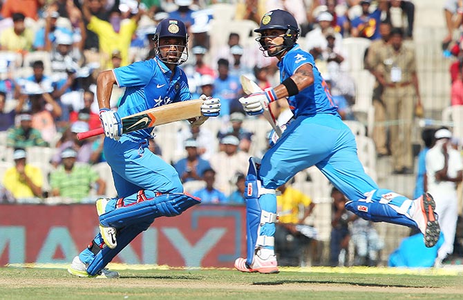 Virat Kohli and Ajinkya Rahane of India run between the wickets 