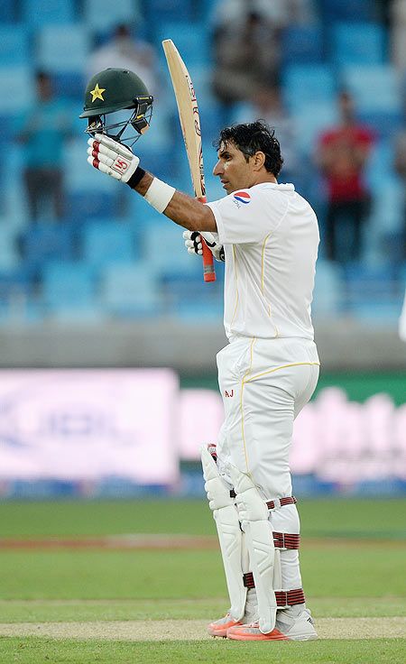Pakistan captain Misbah-ul-Haq salutes the crowd after reaching his century during the 2nd test match between Pakistan and England at Dubai Cricket Stadium