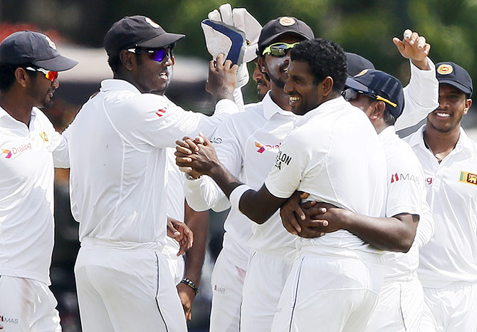 Sri Lanka's Dhammika Prasad (third right) celebrates with his teammates 
