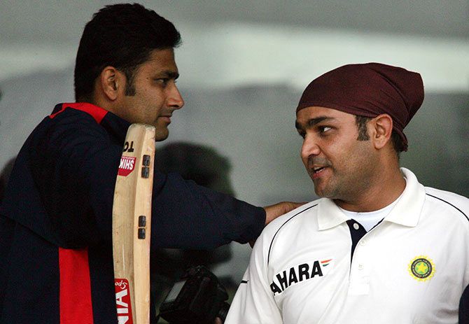 India's Anil Kumble (left) greets team mate Virender Sehwag after the latter scored a century against Pakistan in Lahore in the 2005-06 series
