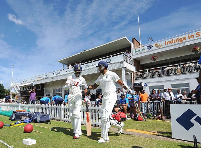 India's Shikhar Dhawan and Murali Vijay walk out to open the batting 