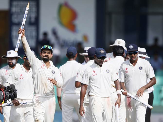 Image result for Virat Kohli, center, celebrates after bowler Ravichandran Ashwin pic