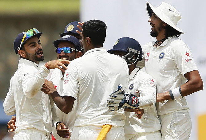 India's captain Virat Kohli (left) celebrates with his teammates including Ravichandran Ashwin  
