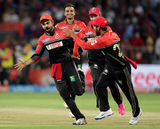 RCB's Virat Kohli celebrates a wicket with teammates
