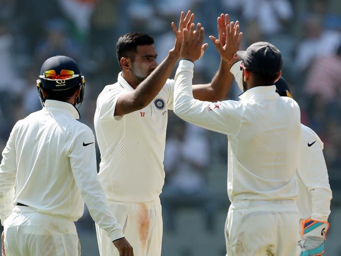 Ravichandran Ashwin, centre, celebrates with team mates after taking the wicket of Jake Ball on Day 2 of the 4th Test at the Wankhede on Friday