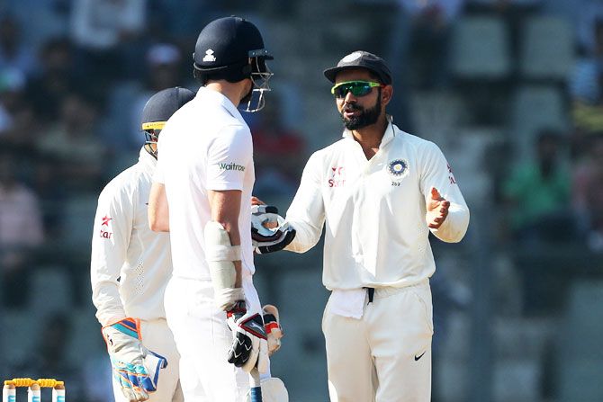 Virat Kohli talks to Jamie Anderson, asking for calm, on Day 5 of the 4th Test in Mumbai on Monday