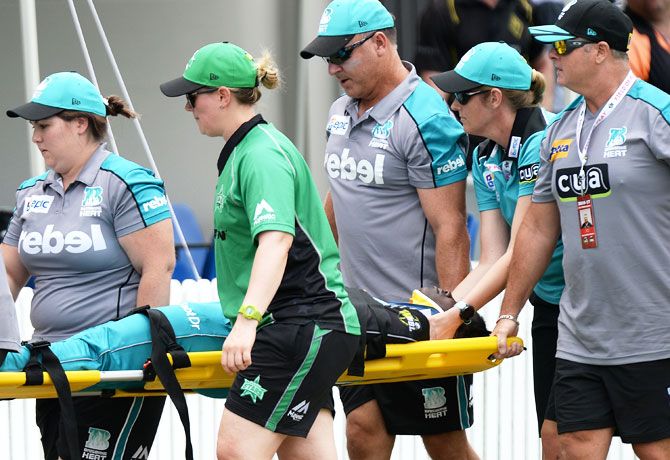 Deandra Dottin of the Brisbane Heat is taken from the field injured after colliding with teammate Laura Harris during their WBBL match against Melbourne Stars at Allan Border Field in Brisbane on Tuesday