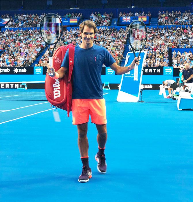 Roger Federer acknowledges the crowd after a practice session in Perth on Thursday
