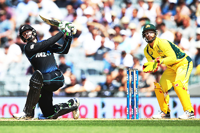 New Zealand's Martin Guptill plays the ball away for six runs