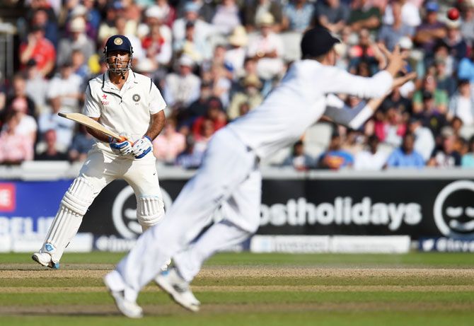 England fielder Gary Ballance prepares to catch India batsman MS Dhoni during day three of the 4th Investec Test match between England and India at Old Trafford on August 9, 2014