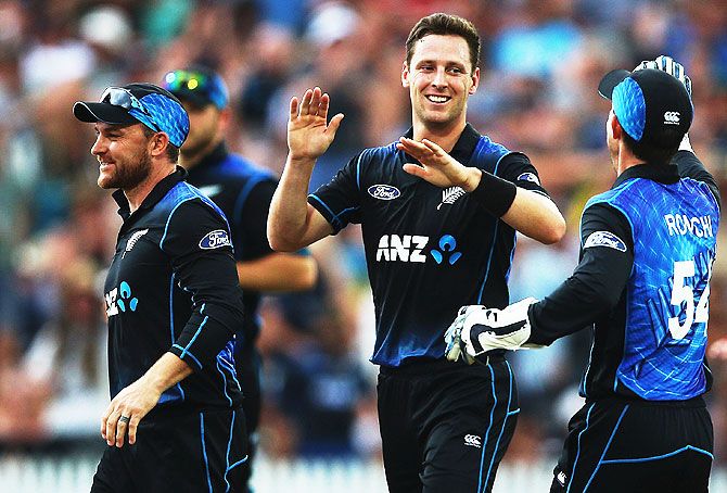 New Zealand's Matt Henry celebrates with Brendon McCullum (left) and other teammates after dismissing Australia's David Warner during the 3rd One Day International at Seddon Park in Hamilton on Monday