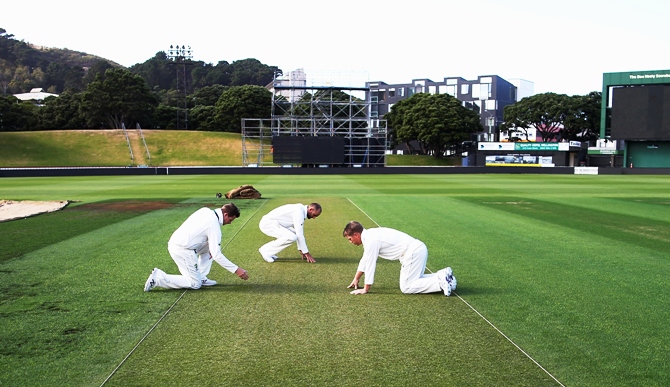Steve Smith, Nathan Lyon and David Warner of Australia inspect the wicket 