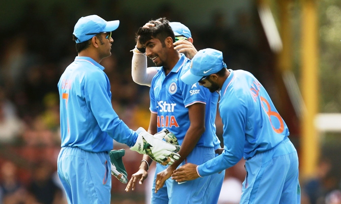 India captain MS Dhoni congratulates Jasprit Bumrah for taking a wicket 