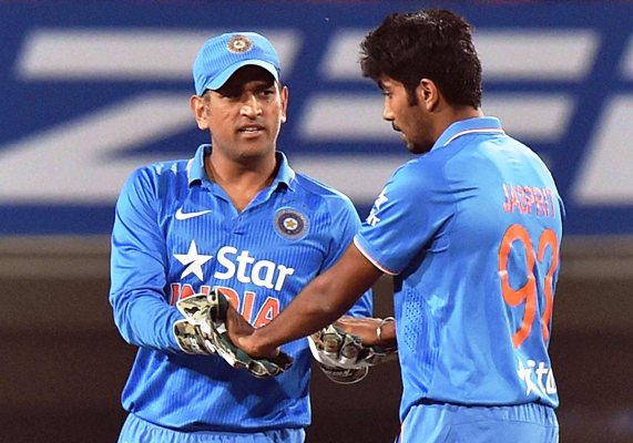 India's captain MS Dhoni celebrates with Jasprit Bumrah during the second T20I against Sri Lanka in Ranchi 