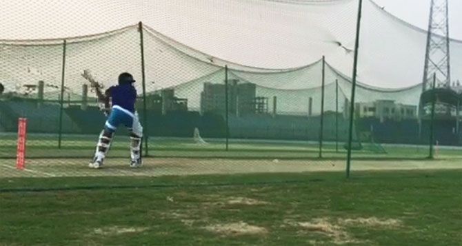 India's opening batsman Shikhar Dhawan bats in the nets during a training session on Tuesday