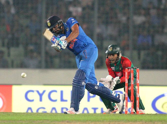India's Rohit Sharma hits a shot during his innings against Bangladesh in the first T20 match at the Asia Cup in Dhaka on Wednesday