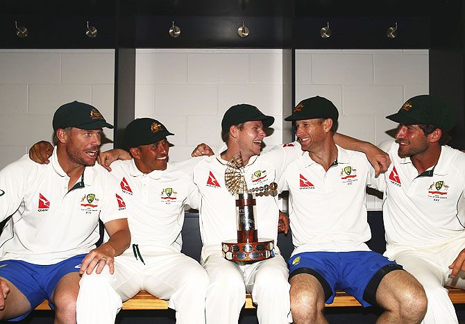 Australia's David Warner, Usman Khawaja, captain Steve Smith, Adam Voges and Joe Burns celebrate with the Trans-Tasman Trophy in the change rooms after winning the Test match against New Zealand at Hagley Oval in Christchurch on Wednesday