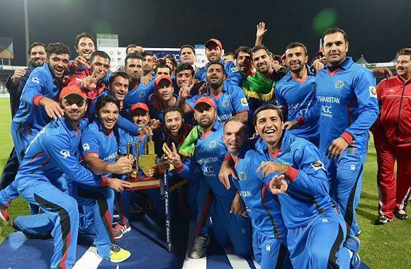 The Afghanistan cricket team celebrate with the trophy after defeating Zimbabwe and win the ODI series 3-2 in Kabul on Wednesday