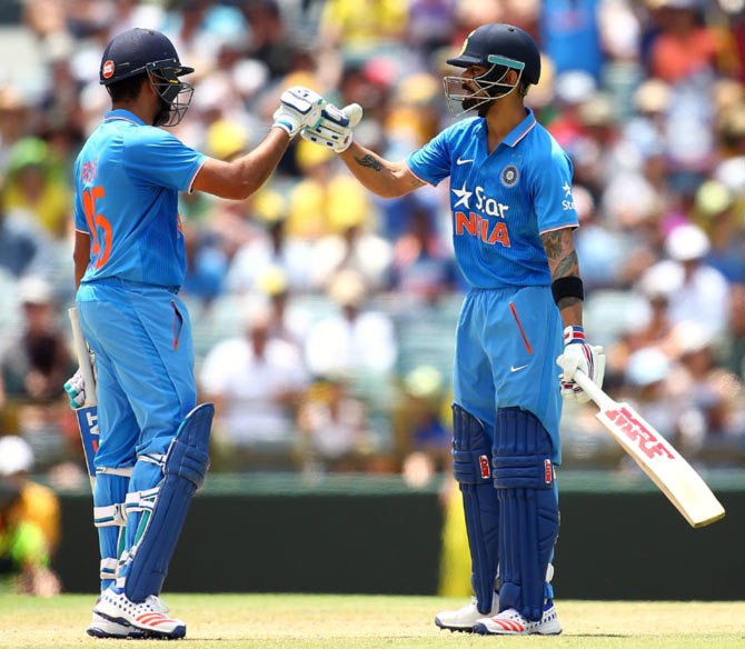 India's Rohit Sharma congratulates teammate Virat Kohli 