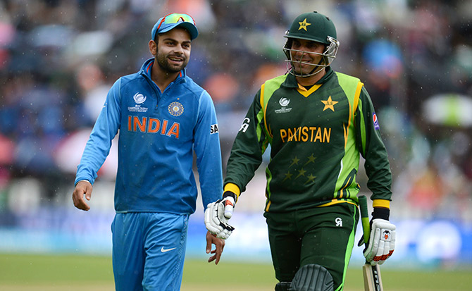 India's Virat Kohli (left) talks to Pakistan's Misbah-Ul-Haq as they leave the field 