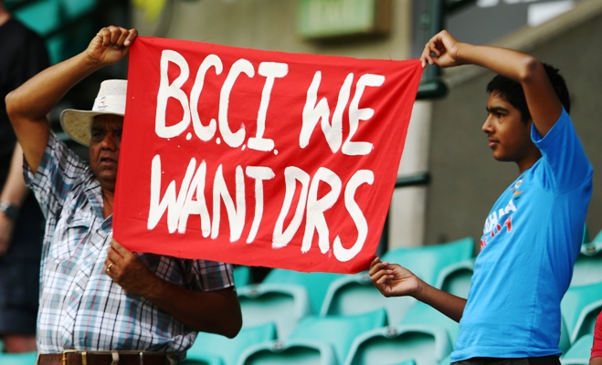 Indian supporters in the crowd hold up a sign about the DRS during a match against Australia 