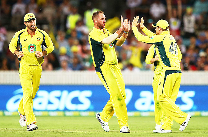 Australia's John Hastings, centre, celebrates a wicket