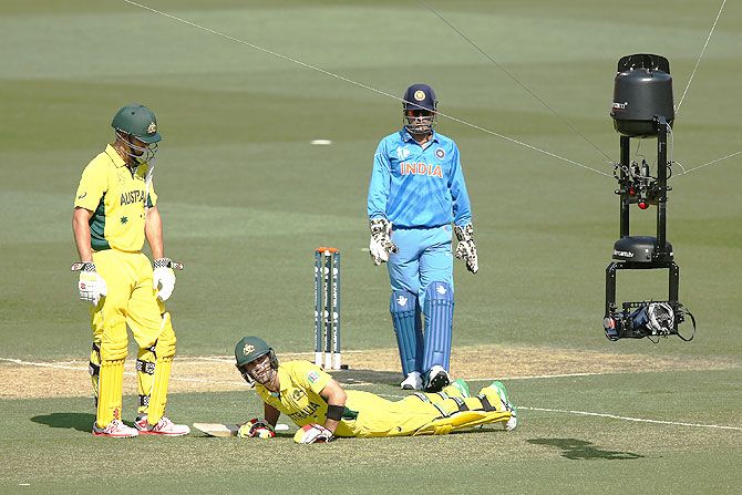The Spider Cam is visible as Glenn Maxwell of Australia reacts after getting cramps during the ICC Cricket World Cup warm up match