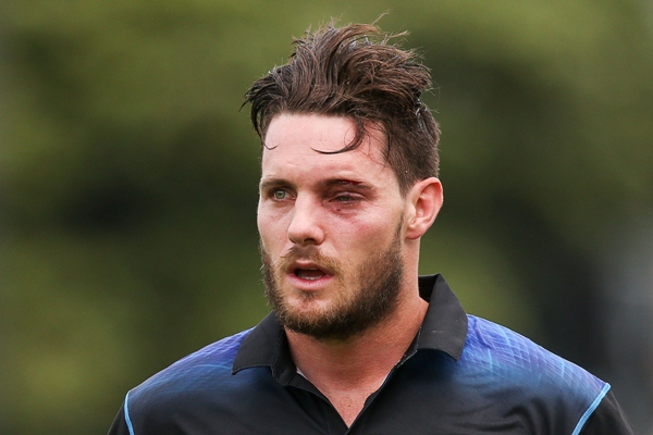 Mitchell McClenaghan of New Zealand leaves the field with an injured eye 
