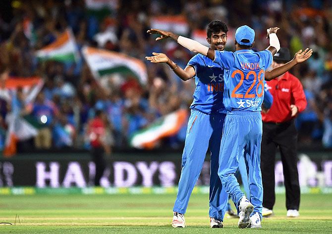 Jasprit Bumrah celebrates with Hardik Pandya after the wicket of Cameron Boyce