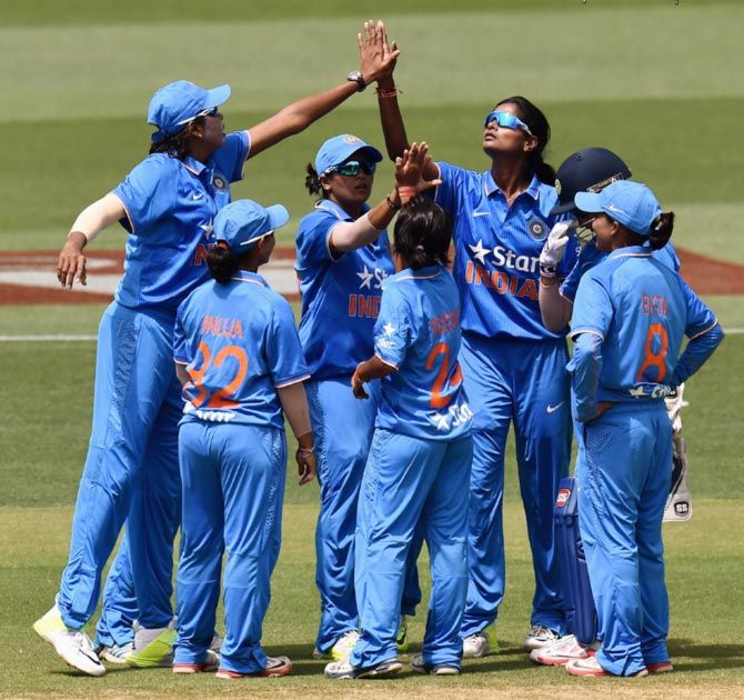 The Indian team celebrate the wicket of Beth Mooney