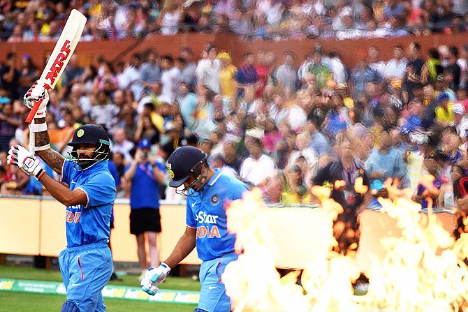 Rohit Sharma and Shikhar Dhawan walk out onto the field to bat in the 1st Twenty20 International match against Australia at Adelaide Oval on Tuesday