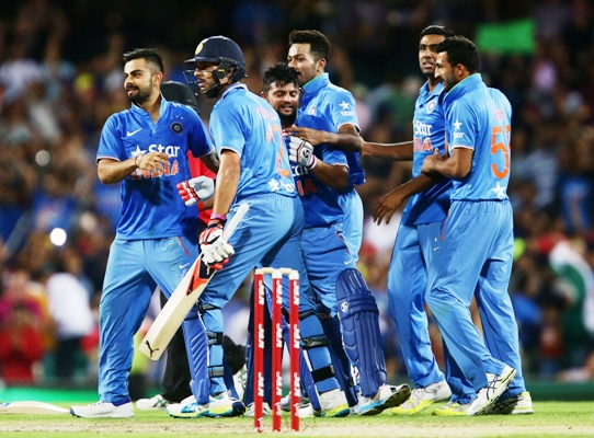 Suresh Raina of India and Yuvraj Singh of India celebrate victory with teammates 