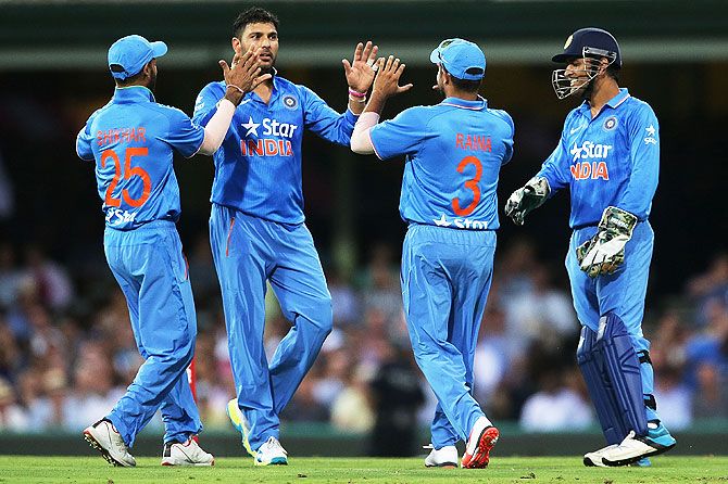 Yuvraj Singh celebrates with teammates after claiming a wicket