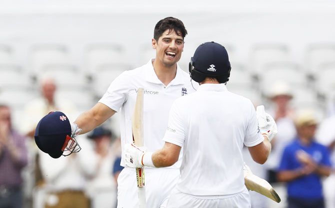 England's Alastair Cook celebrates his century with Joe Root in Day 1 on the 2nd Test on Friday