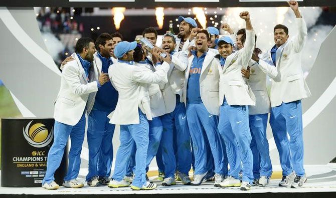 India's team celebrate with the trophy after they won the ICC Champions Trophy final cricket match against England at Edgbaston cricket ground in Birmingham on June 23, 2013