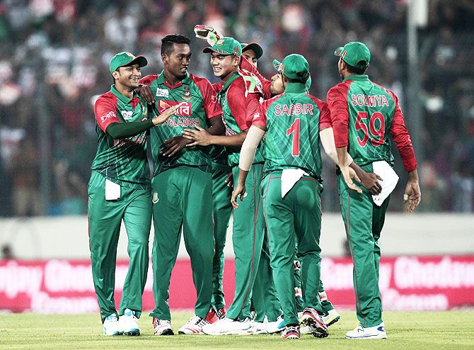 Bangladesh players celebrate the wicket of India's Rohit Sharma