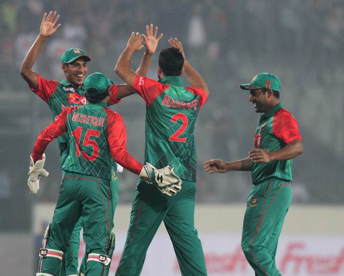 Bangladesh players celebrate the fall of an Indian wicket in the league stage of the Asia Cup
