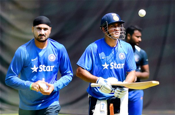 MS Dhoni tosses the ball as Harbhajan Singh bowls during a training session 